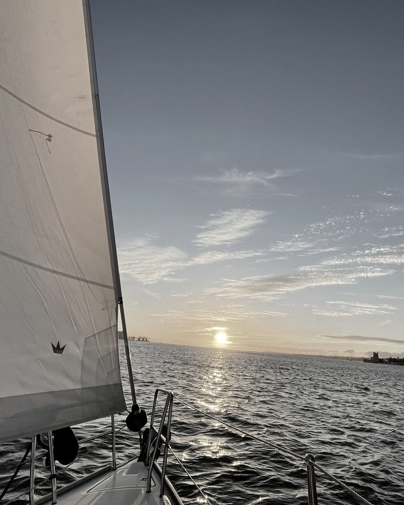Sailing towards the sunset on open water